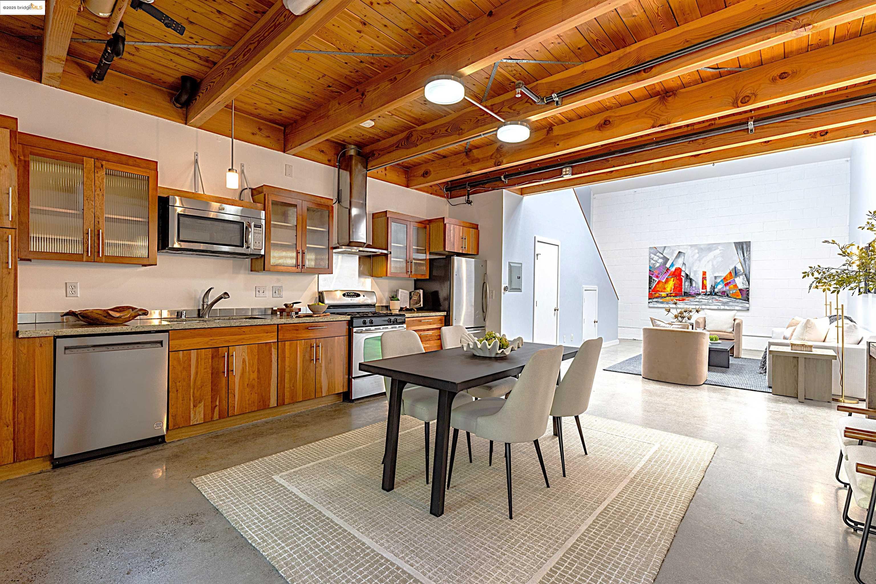 1695 15th Street, Unit 12 Oakland, CA 94607 - Photo 1 of 1 a open kitchen with stainless steel appliances granite countertop a stove a sink dishwasher and cabinets with wooden floor