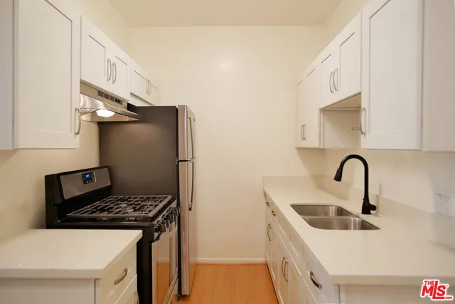 a kitchen with a sink and a stove top oven