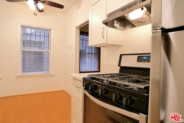 a kitchen with stainless steel appliances granite countertop a stove and a refrigerator
