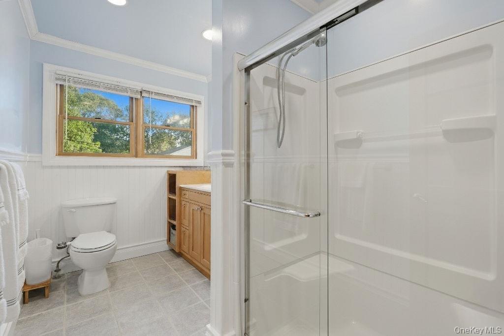 5 Liberty Street Hampton Bays, NY 11946 - Photo 12 of 17 a bathroom with a toilet sink and shower