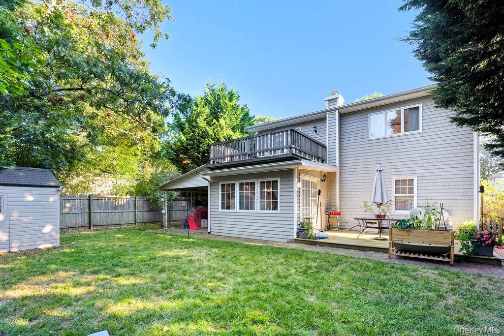 5 Liberty Street Hampton Bays, NY 11946 - Photo 15 of 17 a view of a backyard with a garden and plants