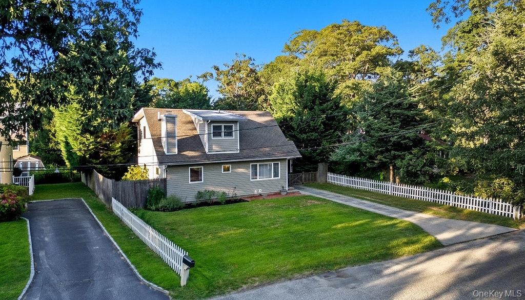 5 Liberty Street Hampton Bays, NY 11946 - Photo 16 of 17 a view of a house with a yard and a large tree