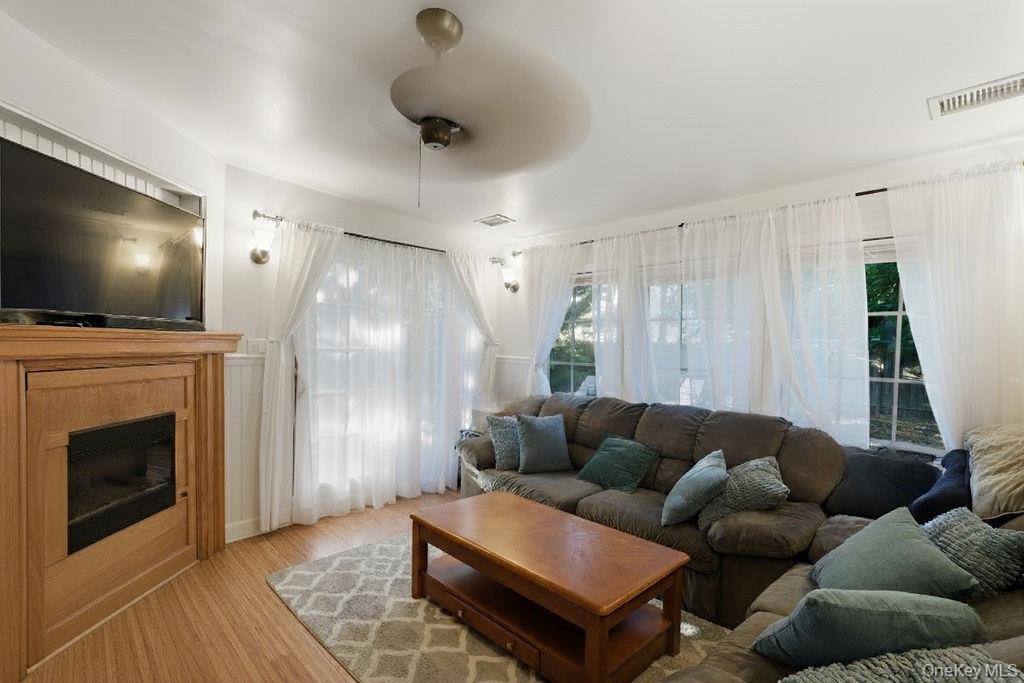5 Liberty Street Hampton Bays, NY 11946 - Photo 7 of 17 a living room with furniture and a flat screen tv