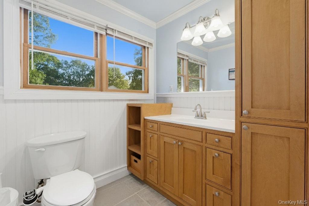 5 Liberty Street Hampton Bays, NY 11946 - Photo 8 of 17 a bathroom with a toilet sink and mirror