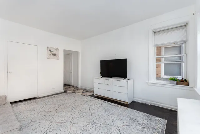 a living room with furniture and flat screen tv