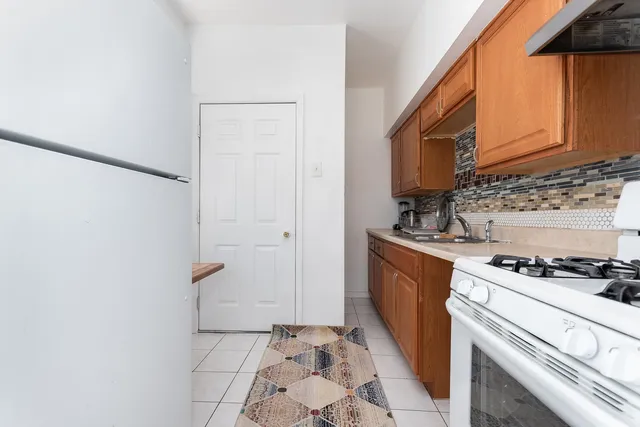 a kitchen with sink cabinets and stove top oven