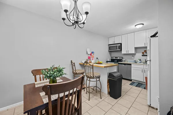 a kitchen with a table and chairs in it