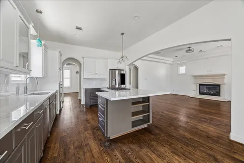 a kitchen with stainless steel appliances a stove top oven and sink