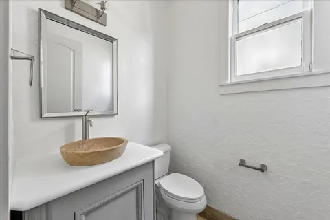 a bathroom with a toilet sink and mirror
