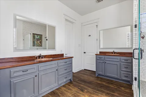 a spacious bathroom with a tub sink and mirror