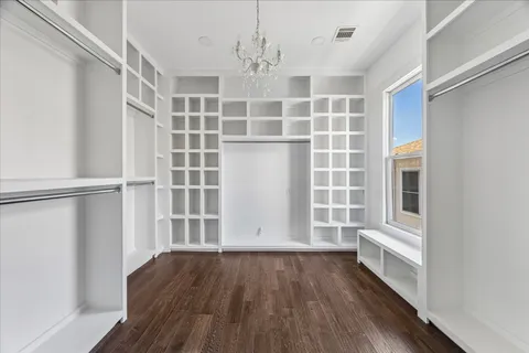 a view of a bedroom with a cabinet and a ceiling fan