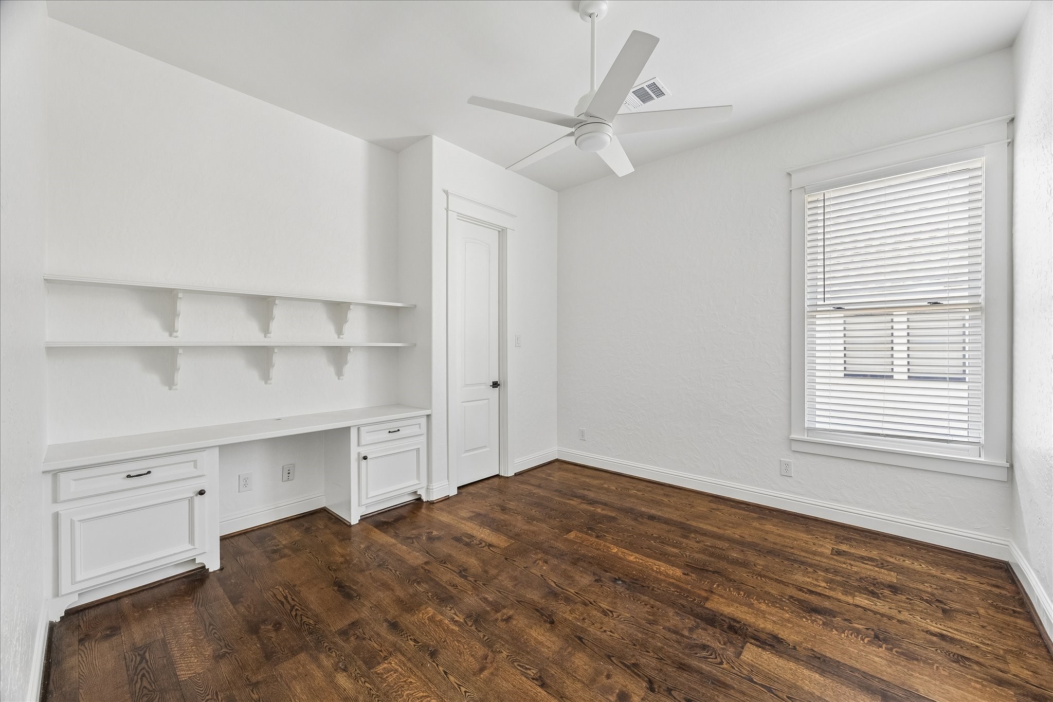 1408 West 23rd Street Houston, TX 77008 - Photo 30 of 39 a view of a bedroom with a cabinet and a ceiling fan