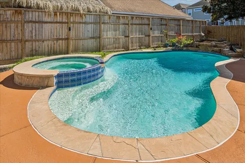 a view of a house with swimming pool and yard