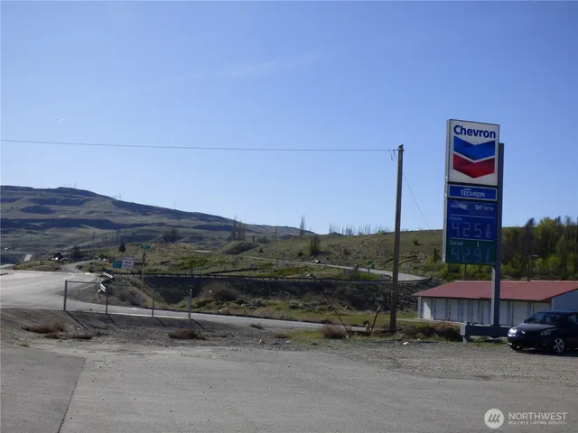 a view of a street with a cars parked on the road