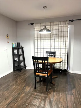 a dining room with furniture and wooden floor