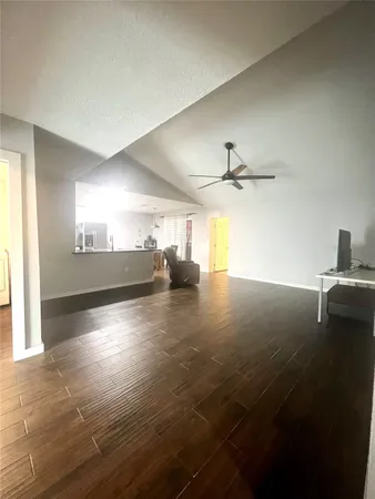 a view of a ceiling fan and wooden floor in a room