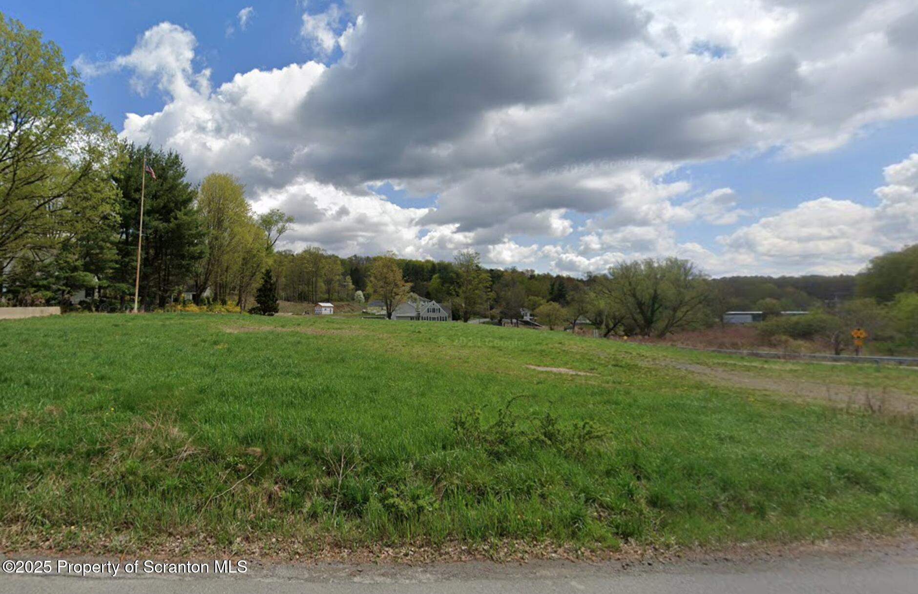 a view of grassy field with trees
