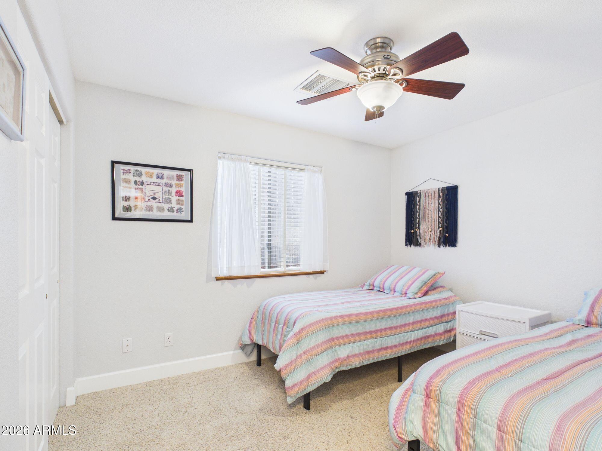 1104 North Rhone Circle Payson, AZ 85541 - Photo 16 of 39 a bedroom with two beds and ceiling fan
