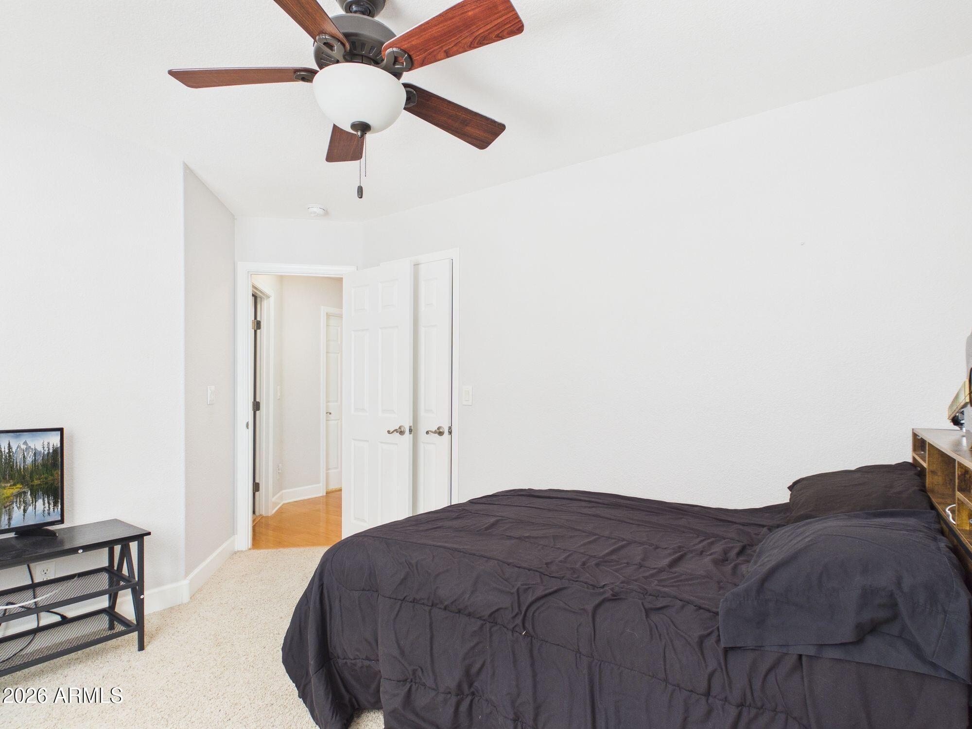 1104 North Rhone Circle Payson, AZ 85541 - Photo 18 of 39 a spacious bedroom with a bed and a ceiling fan