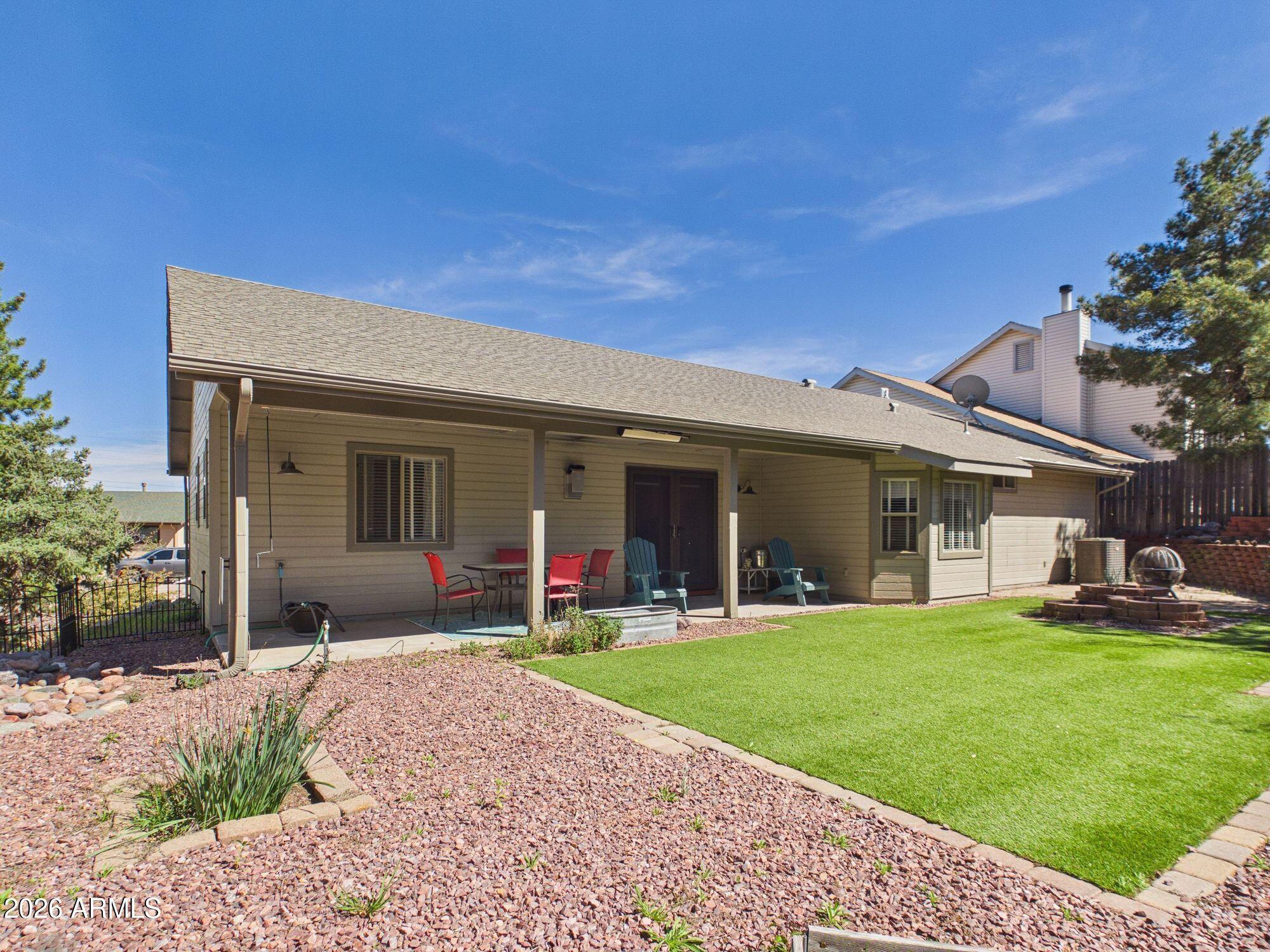 1104 North Rhone Circle Payson, AZ 85541 - Photo 23 of 39 a front view of a house with a yard and potted plants