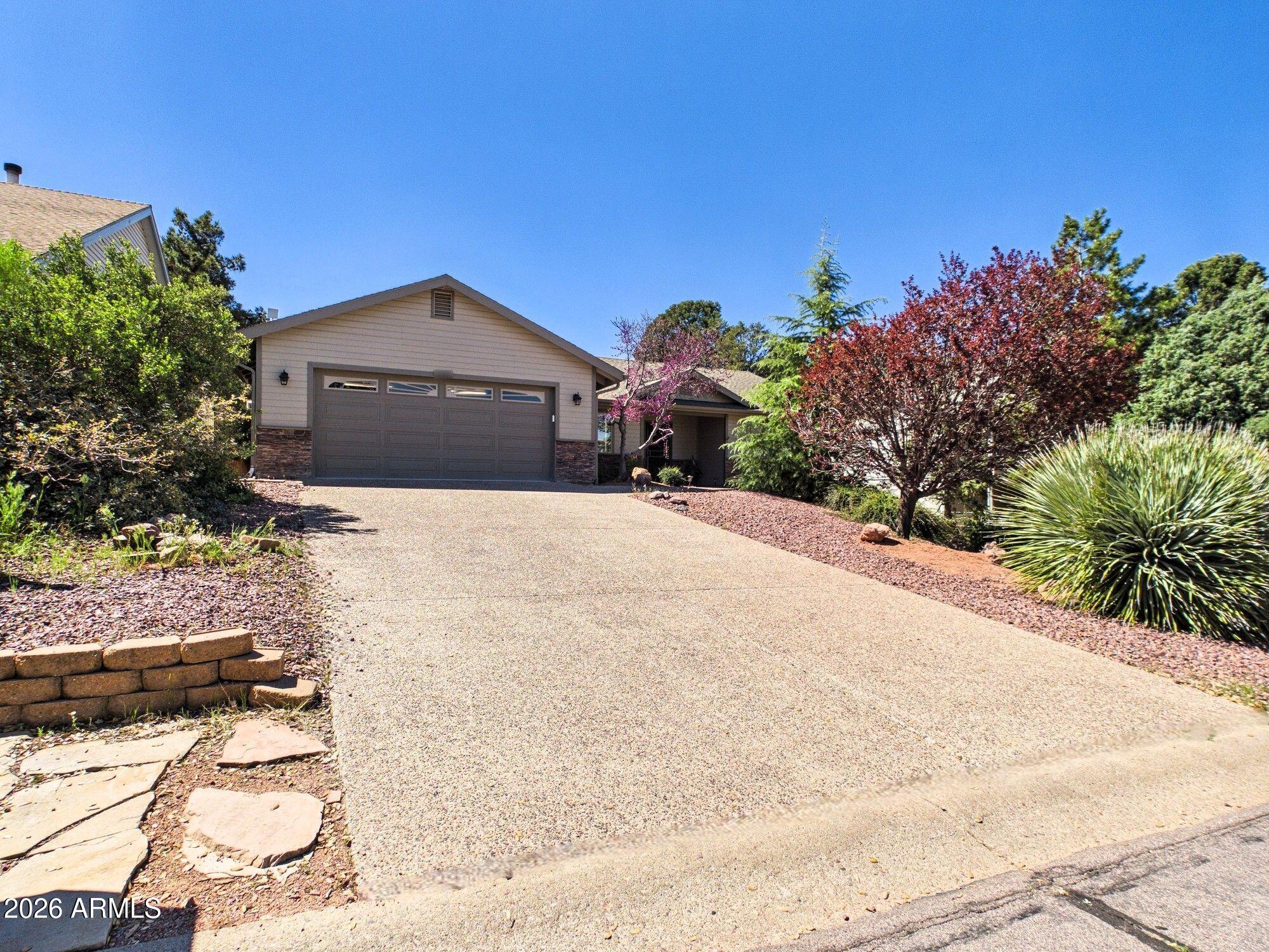 1104 North Rhone Circle Payson, AZ 85541 - Photo 26 of 39 a front view of a house with a yard and garage