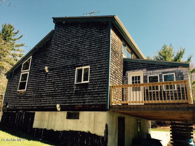 117 Middlefield Road Peru, MA 01235 - Photo 2 of 18 a front view of a house with a balcony