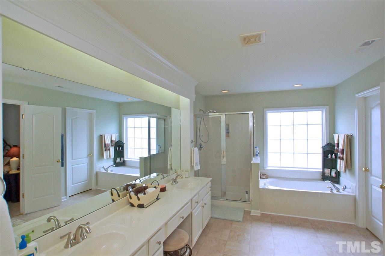 7540 Silver View Lane Raleigh, NC 27613 - Photo 25 of 29 Master bathroom suite has double sink feature as well as separate tub and shower.