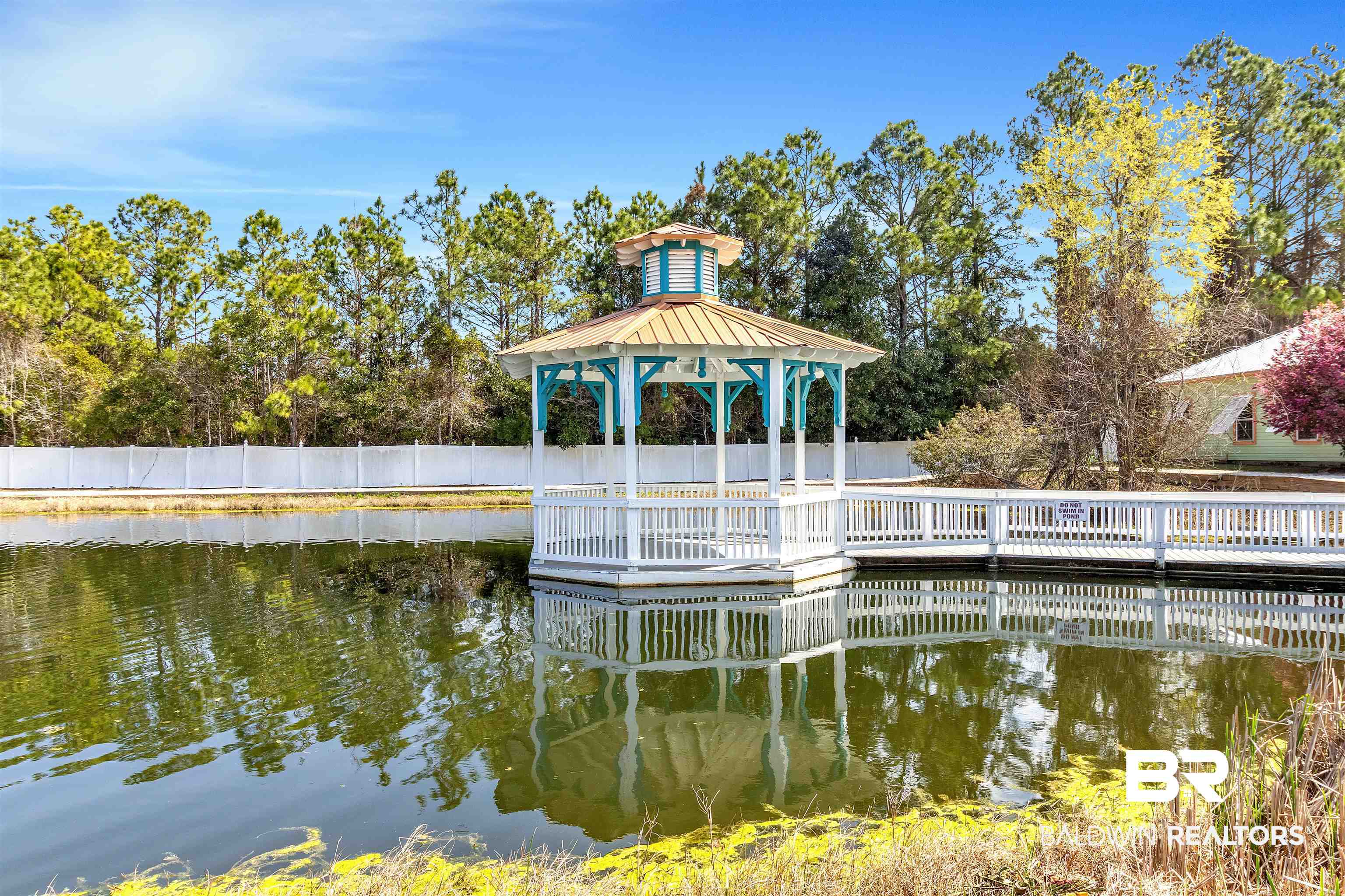 4324 B Lindsey Lane, Unit 4324B Orange Beach, AL 36561 - Photo 18 of 33 Dock area featuring a water view, fence, and a gazebo