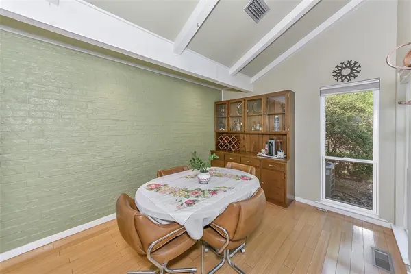 a living room with furniture and kitchen view