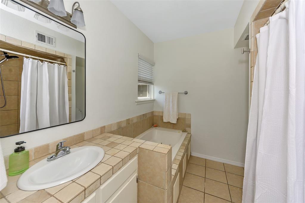 103 Robin Avenue Weatherford, TX 76086 - Photo 20 of 37 a bathroom with a sink and a mirror