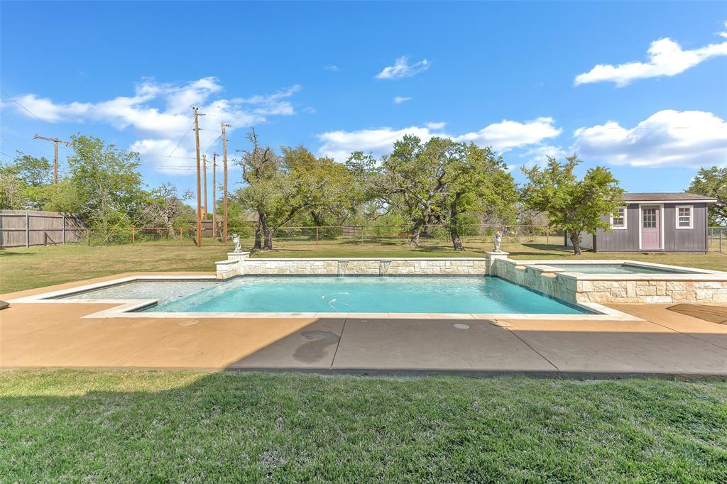 103 Robin Avenue Weatherford, TX 76086 - Photo 25 of 37 a view of a swimming pool with a yard