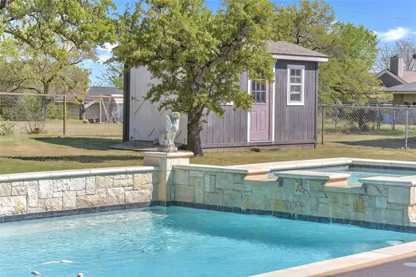 a view of a swimming pool with seating area and furniture
