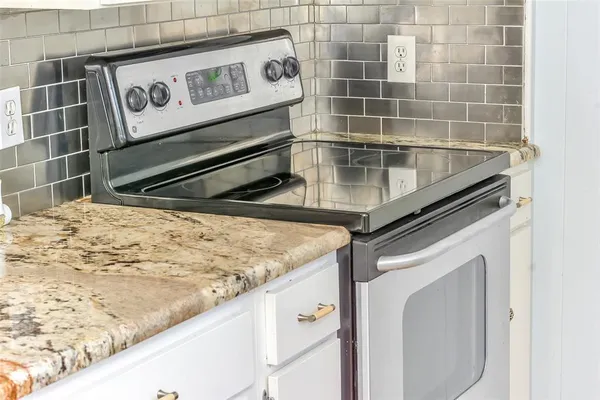 a kitchen with kitchen island a sink stove and refrigerator