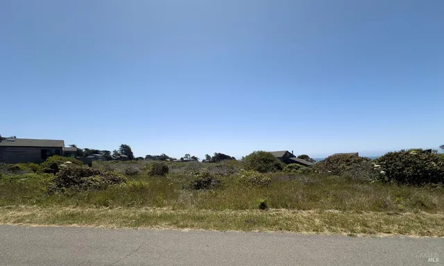a view of a lake next to a mountain