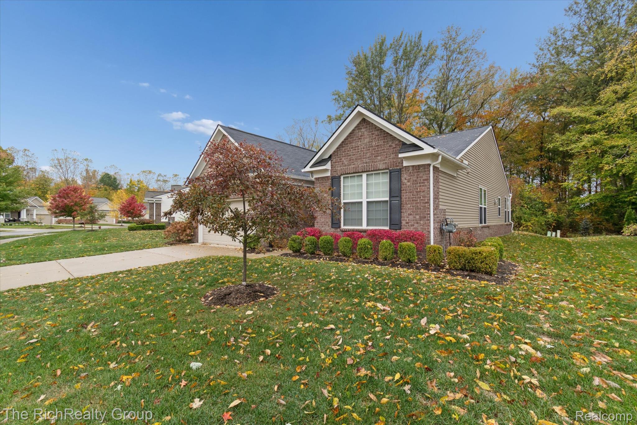 49534 Mapleton Road Canton, MI 48188 - Photo 4 of 37 View of front of property with a front yard, concrete driveway, brick siding, and a garage