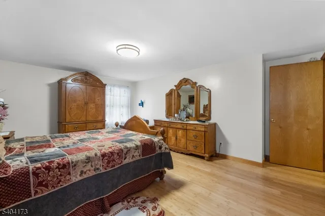 a bedroom with a bed and a dresser