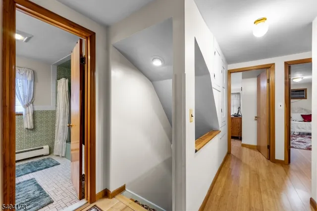 a view of a hallway with wooden floor and stairs