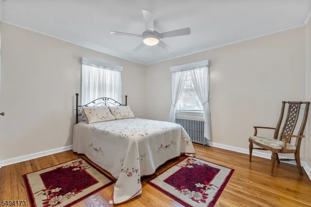 a bedroom with a bed a rug and a window