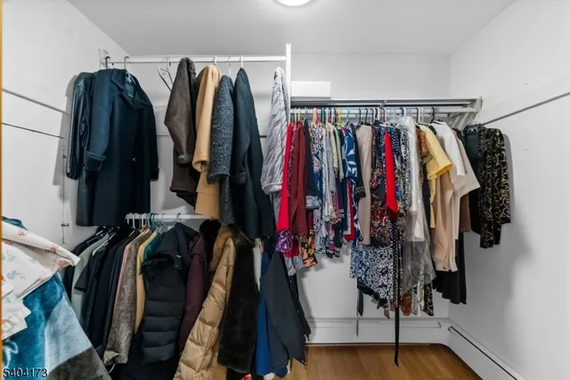 a view of walk in closet with clothes and shoes