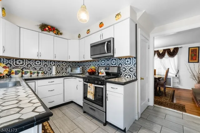 a kitchen with stainless steel appliances granite countertop a stove and a sink
