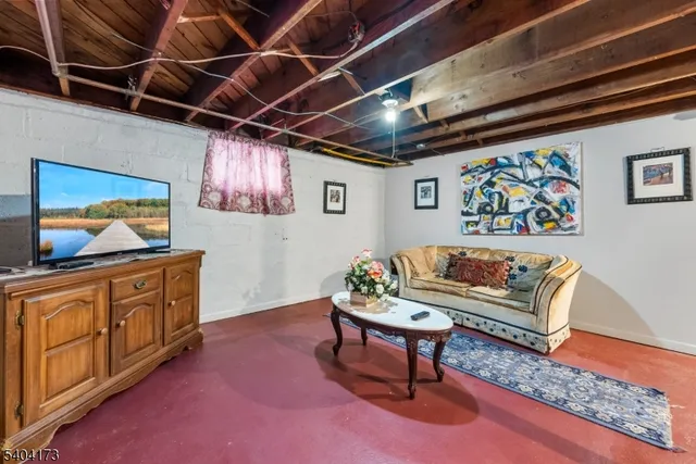 a living room with furniture and wooden floors