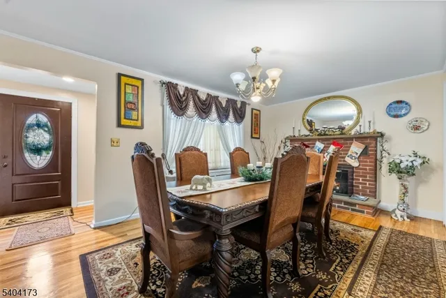 a view of a dining room with furniture and chandelier