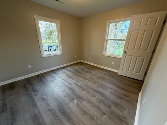 756 Old Summerville Road Northwest Rome, GA 30165 - Photo 18 of 21 a view of an empty room with wooden floor and a window