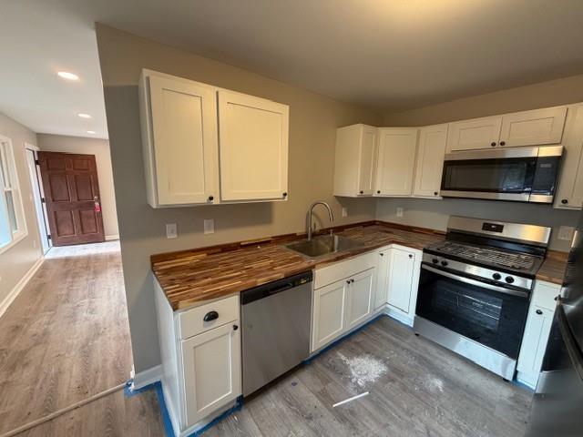 756 Old Summerville Road Northwest Rome, GA 30165 - Photo 8 of 21 a kitchen with stainless steel appliances granite countertop a stove a sink and a microwave