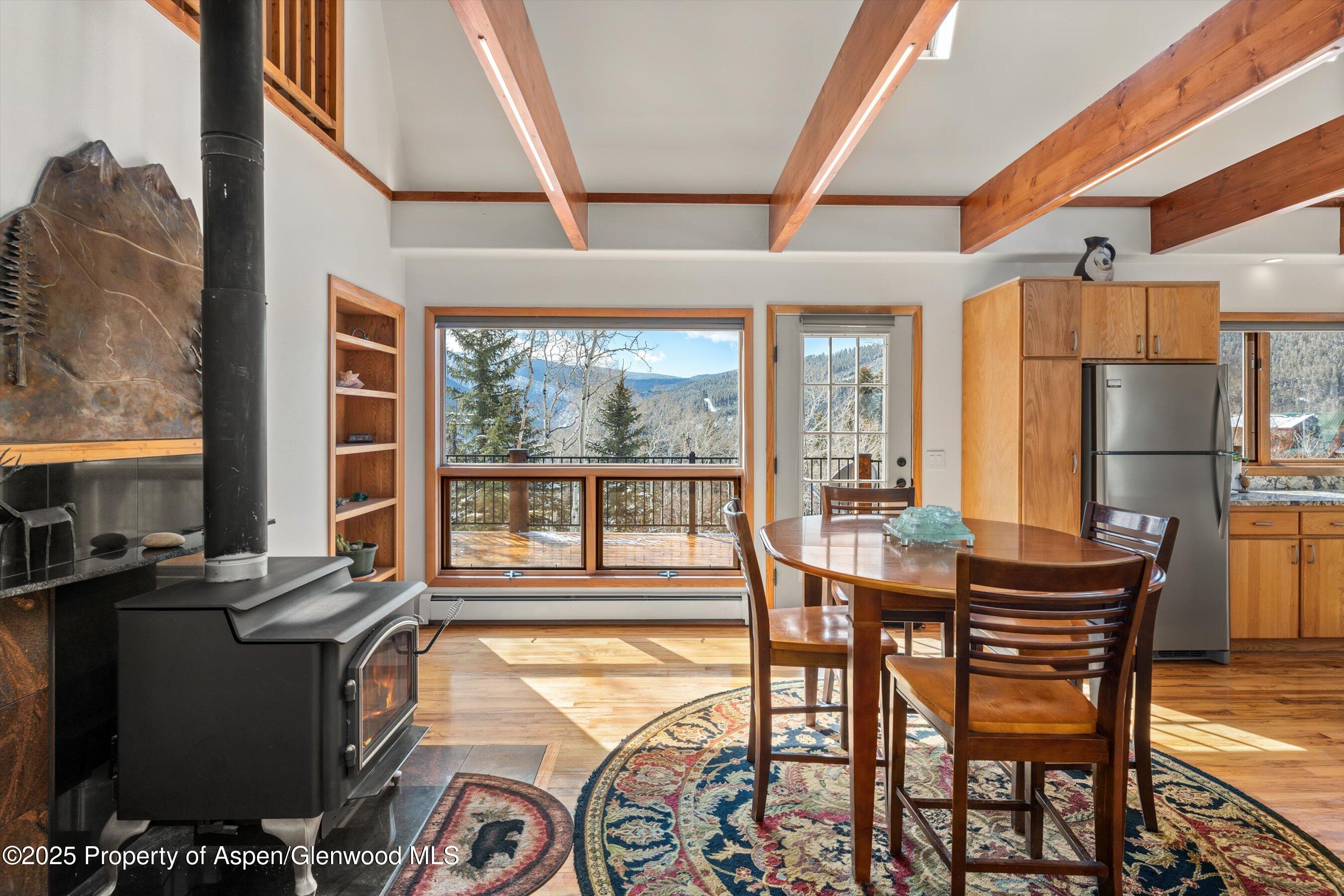 238 Hawk Lane Basalt, CO 81621 - Photo 18 of 46 a dining room with furniture a chandelier and wooden floor