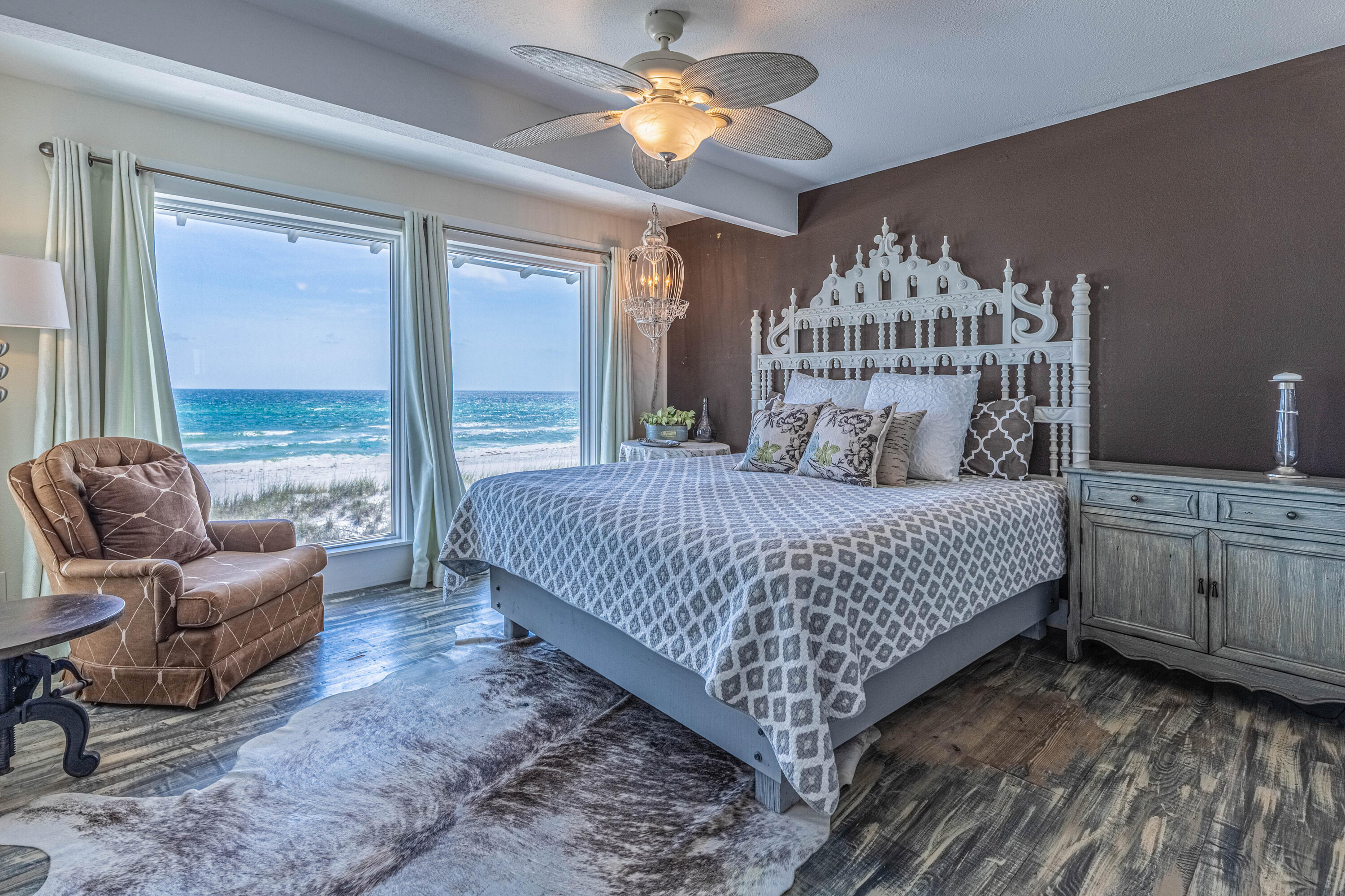 17807 Front Beach Road Panama City Beach, FL 32413 - Photo 16 of 17 a bedroom with a bed a couch and a chandelier