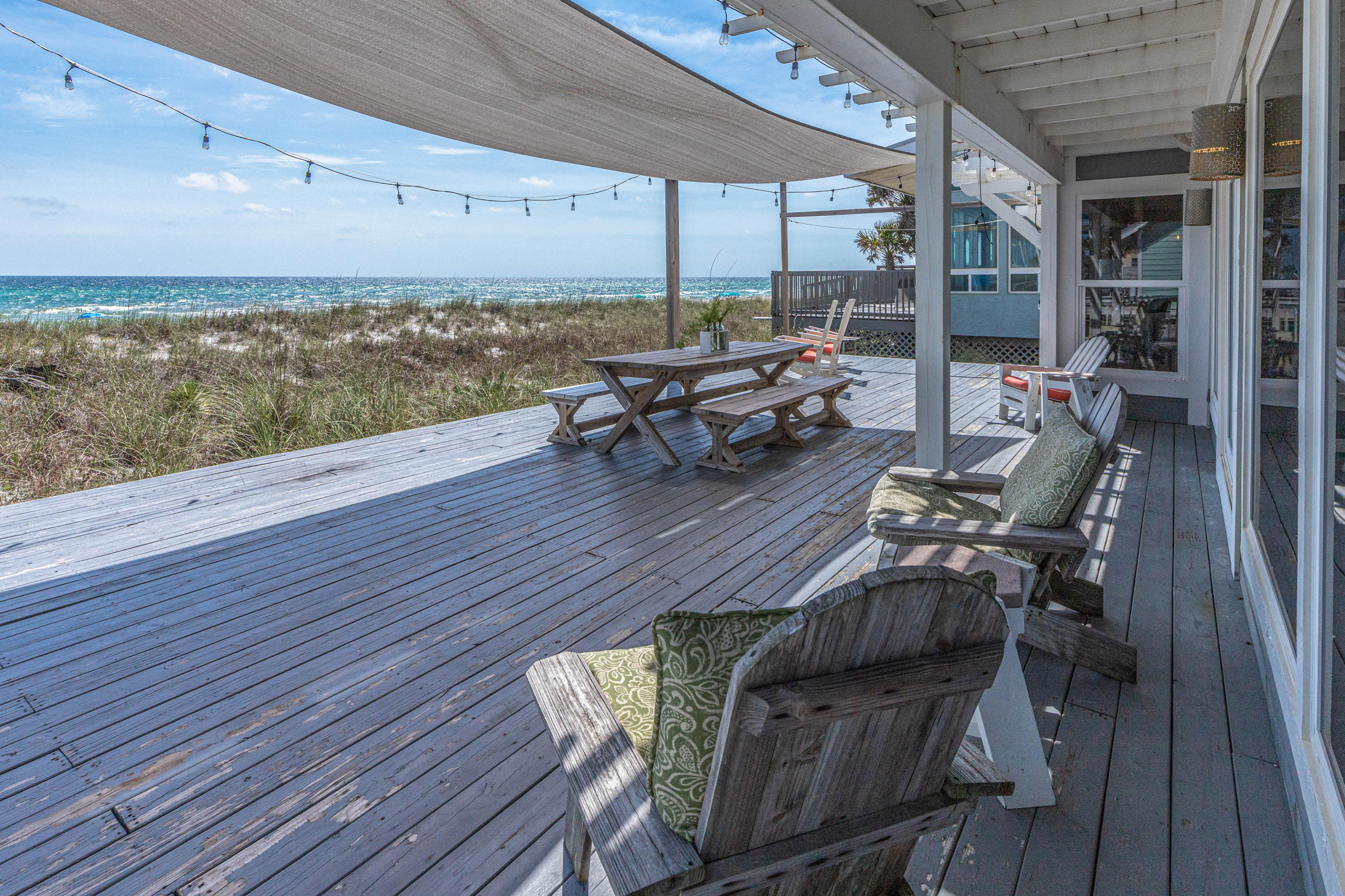 17807 Front Beach Road Panama City Beach, FL 32413 - Photo 5 of 17 a living room with patio furniture and wooden floor