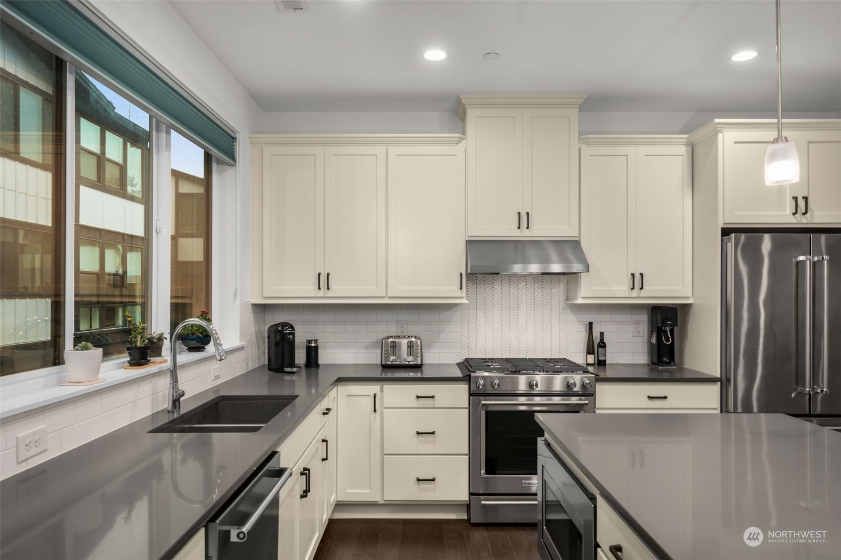 9604 Main Street, Unit B Bothell, WA 98011 - Photo 12 of 34 a kitchen with granite countertop a sink stainless steel appliances and cabinets