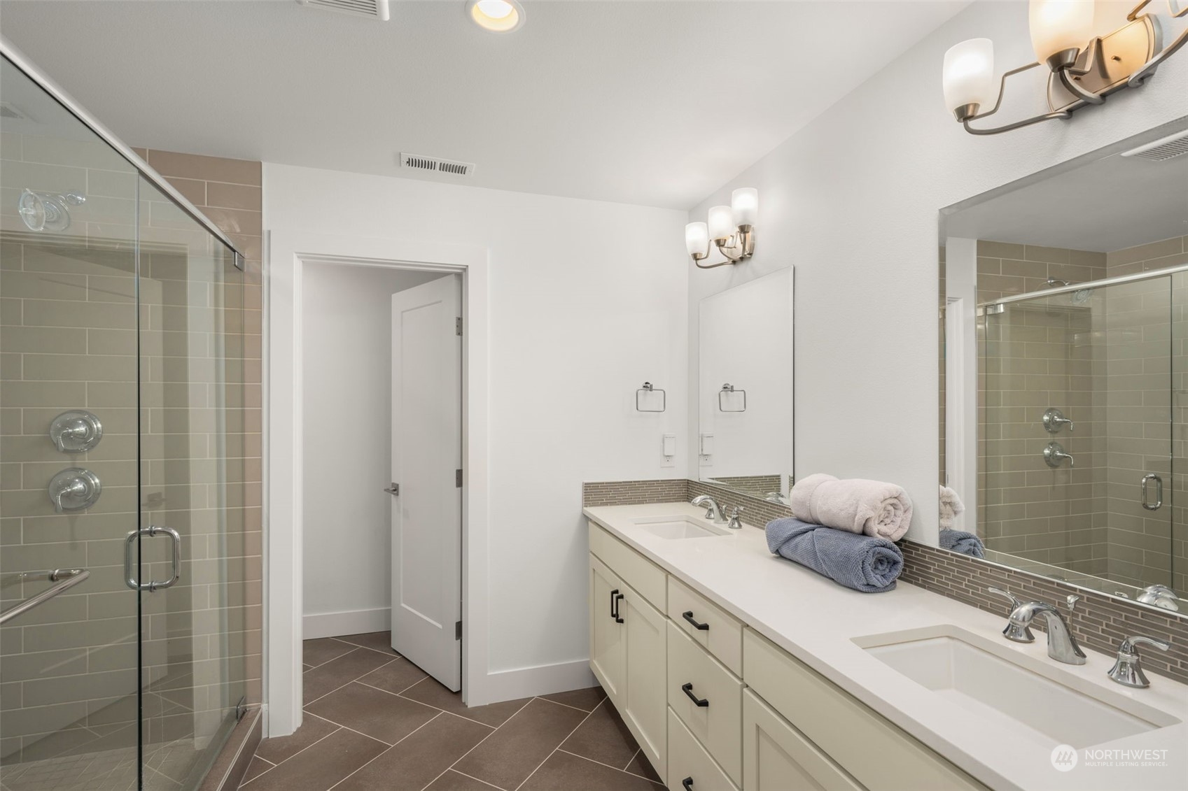 9604 Main Street, Unit B Bothell, WA 98011 - Photo 17 of 34 a bathroom with double vanity sinks and a shower