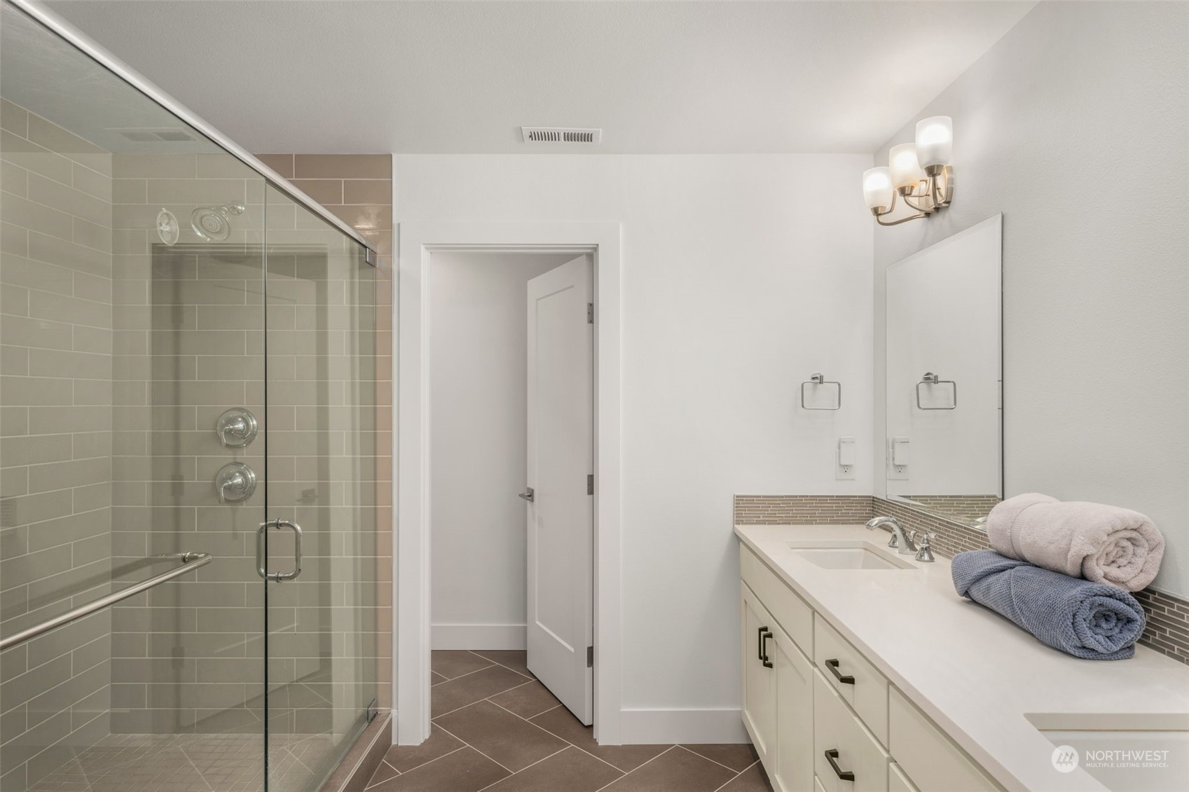 9604 Main Street, Unit B Bothell, WA 98011 - Photo 18 of 34 a spacious bathroom with a shower and a sink